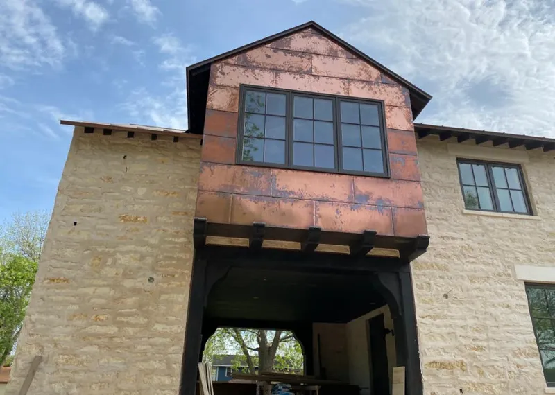 Copper metal panel facade on a stone building for Metal Roof Coating in Lake City